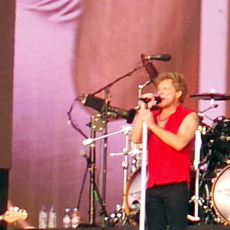 Jon Bon Jovi singing on stage with the band