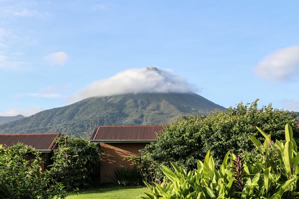 Arenal Volcano in Costa Rica rising in a near-perfect cone above green rainforest