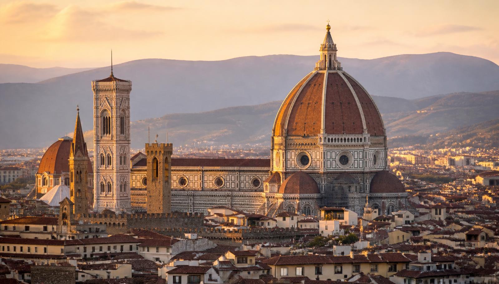 The terracotta dome of Florence Cathedral rising above rooftops with hills behind